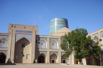 Mohammed Amin Khan Madrassah with Kalta Minor minaret in the backkground. Khiva, Uzbekistan.