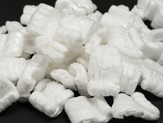 pieces of white foam on a black background.expanded polystyrene