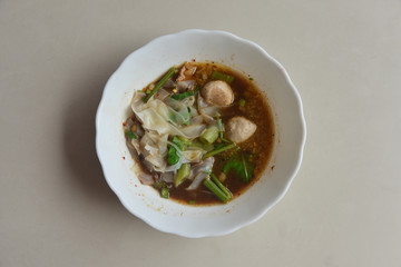 Thai Noodle With Stewed Soup (Kuay Tiew Ruer) served with Pork Ball and Pork. This is one of popular street food menu in Thailand. 