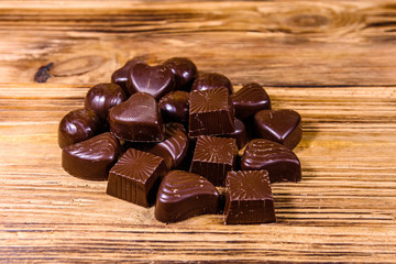 Heap of chocolate candies on a wooden table