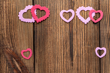 Present gift card with hearts and flowers for Valentine day on the wooden background