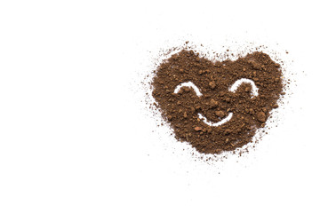 The soil on a white background with a heart shape conveys love and care.