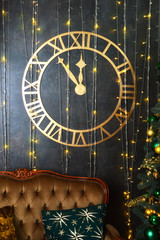 Waiting for the New year and Christmas. A clock on the wall and a brown sofa. Prepare for a happy holiday.