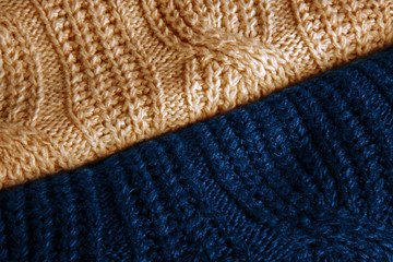 Stylish knitted fabrics of sweaters beige and classic blue color with a pattern.