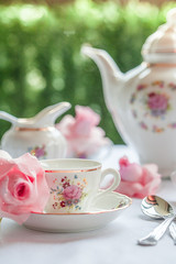 A set of  floral rose pattern fine china porcelain tea set with a tea-pot, sugar pot, creamer, and...