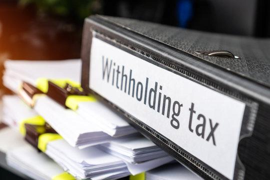 Pile Of Taxation Document Files Concept : Withholding Tax, Retention Tax Is Income Tax To Paid To Government By Payer Rather Than By  Recipient, Applies To Employment Income, Recipient's Tax Liability