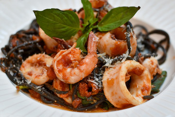 Close-up view, Black Seafood Spaghetti in white plate.