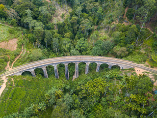 Fototapeta na wymiar Aerial view of Nine Arch Bridge a very picturesque spot in Ella, Sri Lanka. Ella is a mountain town in the Central Highland of Sri Lanka surrounded by the beautiful greens of tea.