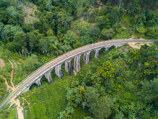 Fototapeta premium Aerial view of Nine Arch Bridge a very picturesque spot in Ella, Sri Lanka. Ella is a mountain town in the Central Highland of Sri Lanka surrounded by the beautiful greens of tea.