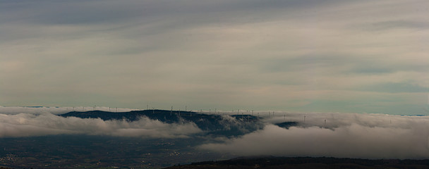 Fototapeta na wymiar Panoramic image of a mountain range full of wind turbines