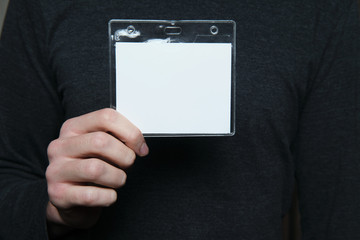 Man holding security badge with blank copy space