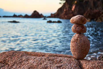 Fototapeta na wymiar Three stones in balance by the sea