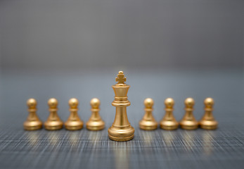golden chess pieces on dark background
