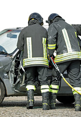 brave firefighters who open the destroyed door of a car using a