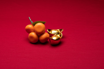 Chinese New Year decorations in red background with assorted festival decorations. Chinese characters in gold decoration means generous of wealth, prosperity and luck

