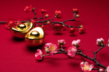 Chinese New Year gold and flowers decorations in red background with assorted festival decorations. Chinese characters in decoration means generous of wealth, prosperity and luck