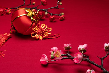 Chinese New Year flower decorations in red background with assorted festival decorations.

