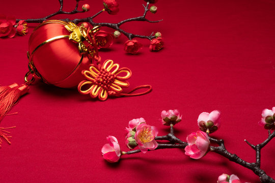Chinese New Year flower decorations in red background with assorted festival decorations.

