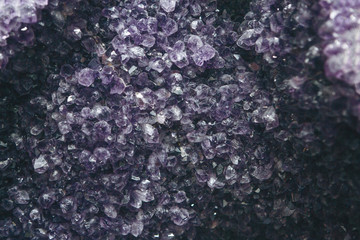 Close-up or macro of a lilac or violet mineral of amethyst druse