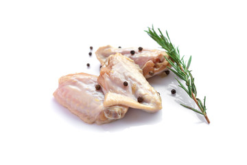 Raw chicken wings with garlic, pepperand rosemary isolated