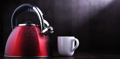 Red stainless steel stovetop kettle with whistle