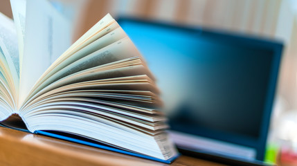 Open book lying on the table in the library