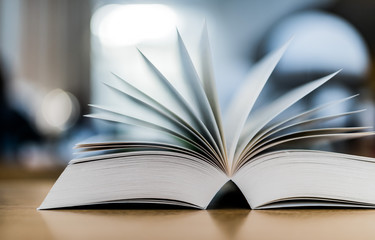 Open book lying on the table in the library