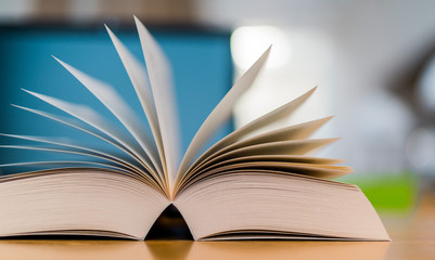 Open book lying on the table in the library