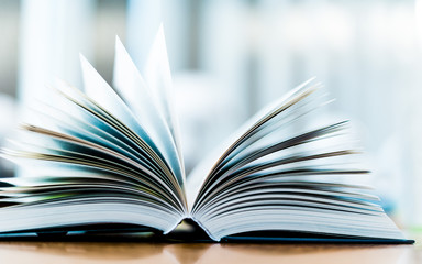 Open book lying on the table in the library