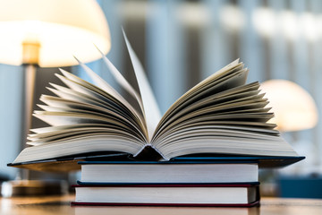 Open book lying on the table in the library