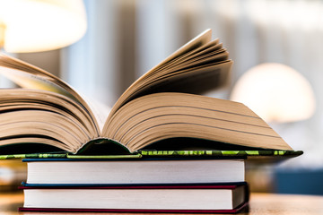 Open book lying on the table in the library