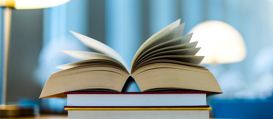 Open book lying on the table in the library