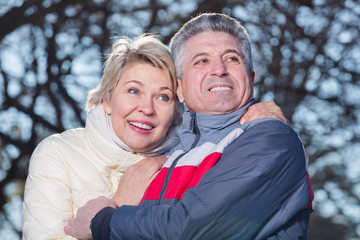 Mature couple hugging each other in park