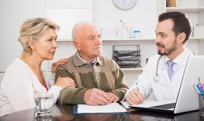 Old father with daughter visit doctor