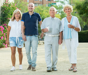 positive elderly friends walking outdoor