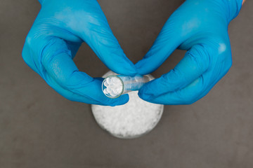 Plastic granules . Polyethylene pellets and hands with gloves. Quality control of plastic in the laboratory in production. BPA FREE.