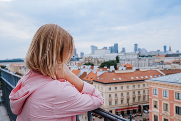 Fototapeta na wymiar Attractive blonde woman looking at old and new city in Warsaw, Poland