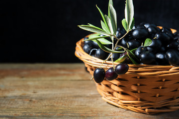 A wiker basket full with ripe fresh black olives from Puglia, Italy, low key