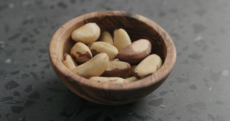 brazil nuts in olive bowl on terrazzo countertop