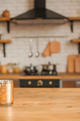 Christmas kitchen decor and copy space. Rustic kitchen in defocus. Wooden table in focus.