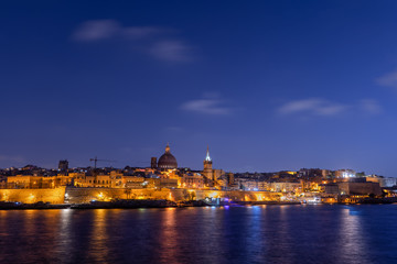 Fototapeta na wymiar City of Valletta at evening twilight, capital of Malta skyline from the sea