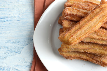 closeup top view cinnamon churros on a plate