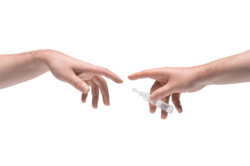 Two male hands passing one another small plastic phial with clear liquid on white background