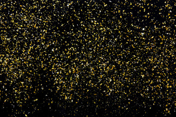 Fototapeta na wymiar Golden glitter texture on black abstract background