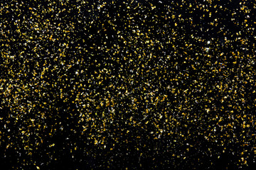 Golden glitter texture on black abstract background