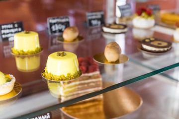 cafeteria, bakery shop with various kinds of bakery such as cookies, cakes, pastries, shopping area.variety of desserts and cakes in the window of a pastry shop.Selective focus.Patisserie