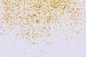 Golden glitter texture on white abstract background
