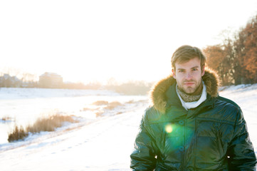 Polar explorer. Sunny winter day. Winter menswear. Winter outfit. Hipster fashion outfit. Guy jacket hood. Man warm jacket snowy nature background. Wind resistant clothes. Winter weather conditions