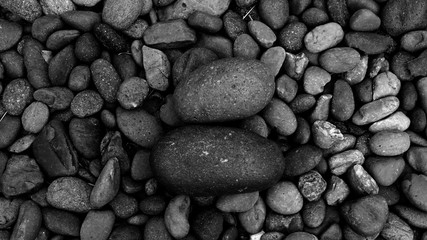 black pebbles on the beach background