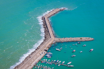 Marina breakwater of Cefalu city on the Tyrrhenian Sea, Sicily Island in Italy - view from Cefalu Rock